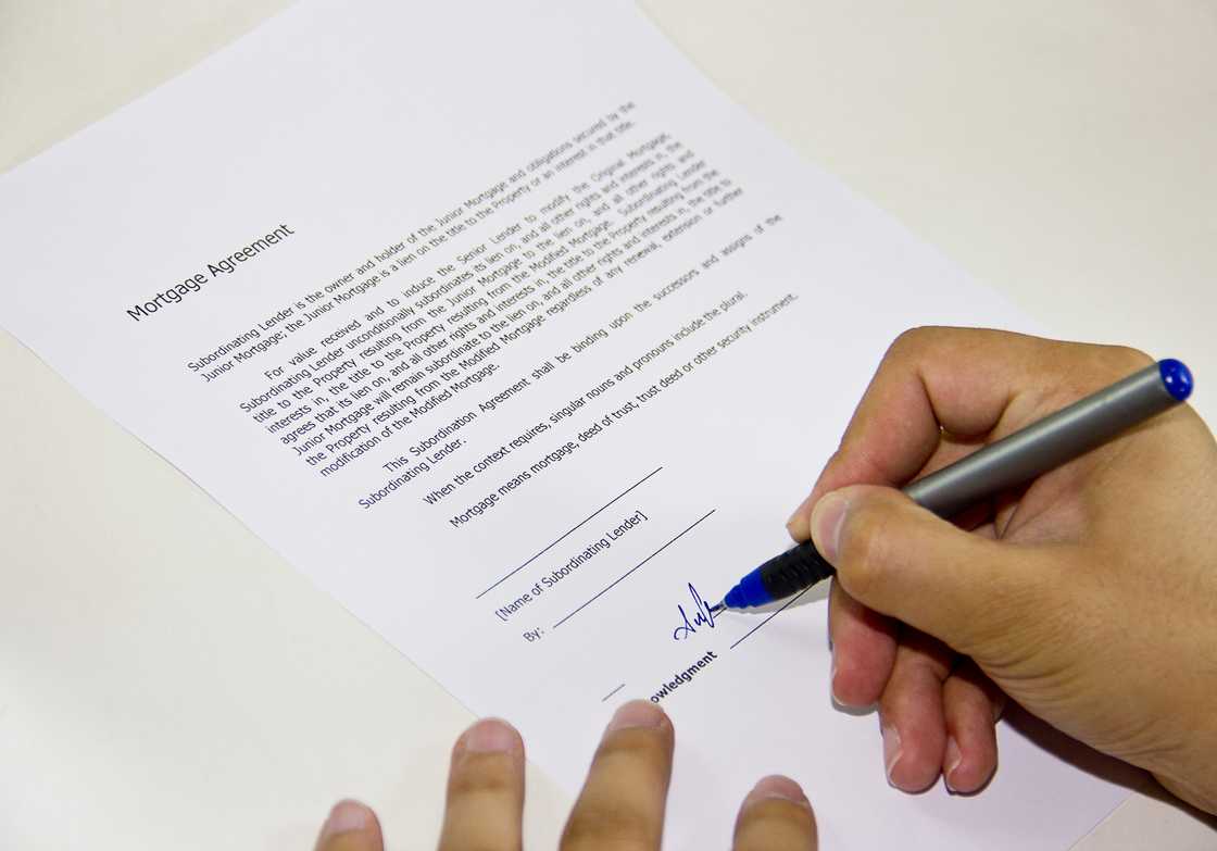 Someone putting a signature on a letter Someone putting a signature on a letter