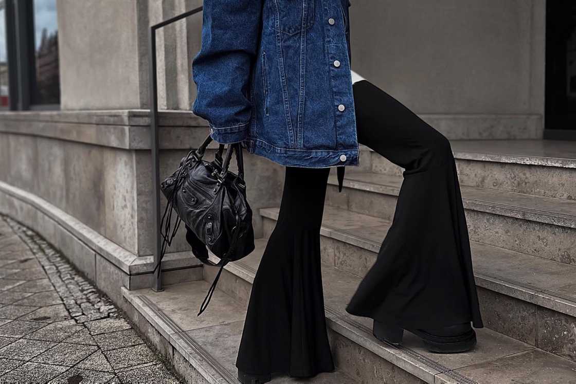 A woman is rocking a pair of black flared pants A woman is rocking a pair of black flared pants