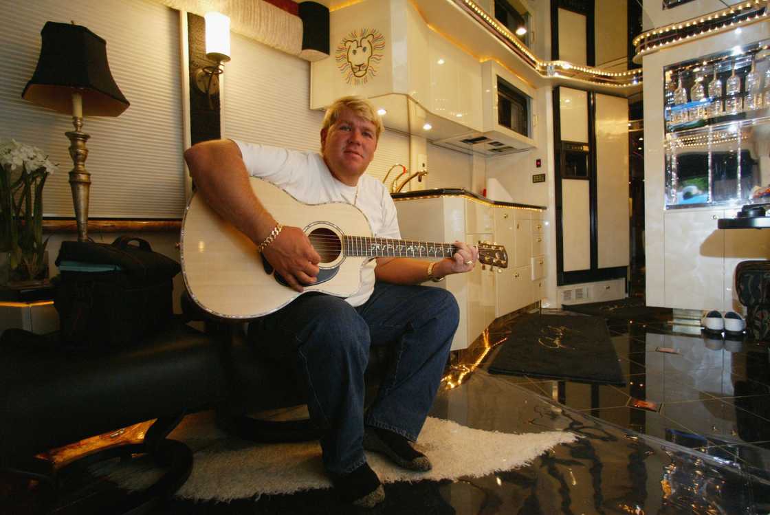 John Daly plays the guitar in his motorhome prior to the start of the U.S. John Daly plays the guitar in his motorhome prior to the start of the U.S.