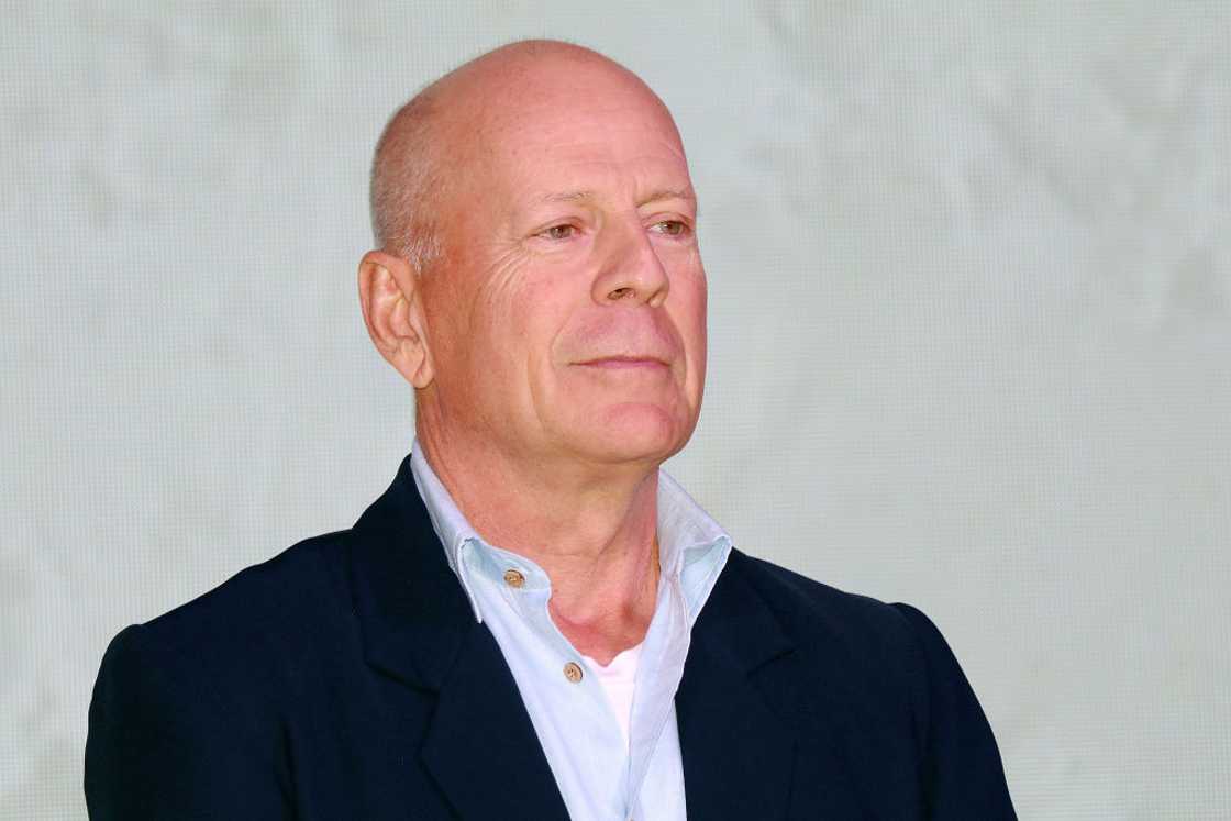 American actor Bruce Willis in a blue shirt and black coat American actor Bruce Willis in a blue shirt and black coat