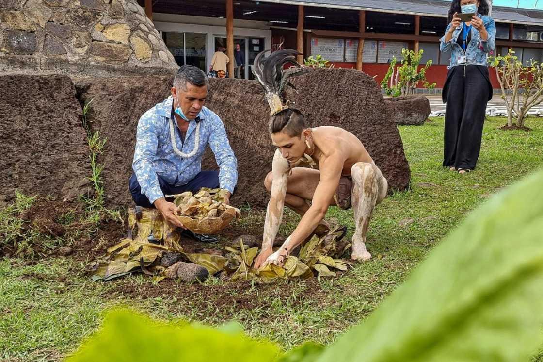 Easter Islanders pay their respects to the Mother Earth outside the island's airport ahead of the arrival of the first tourists in 28 months Easter Islanders pay their respects to the Mother Earth outside the island's airport ahead of the arrival of the first tourists in 28 months