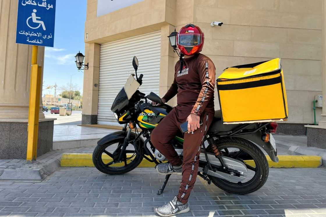 A Pakistani delivery worker poses for a photo during a break in the Saudi capital Riyadh A Pakistani delivery worker poses for a photo during a break in the Saudi capital Riyadh