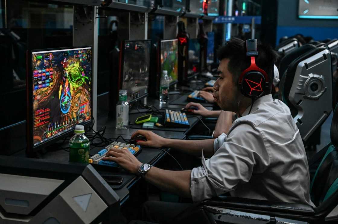 At an internet cafe in the capital Beijing, gamers tapped furiously on multicoloured keyboards At an internet cafe in the capital Beijing, gamers tapped furiously on multicoloured keyboards