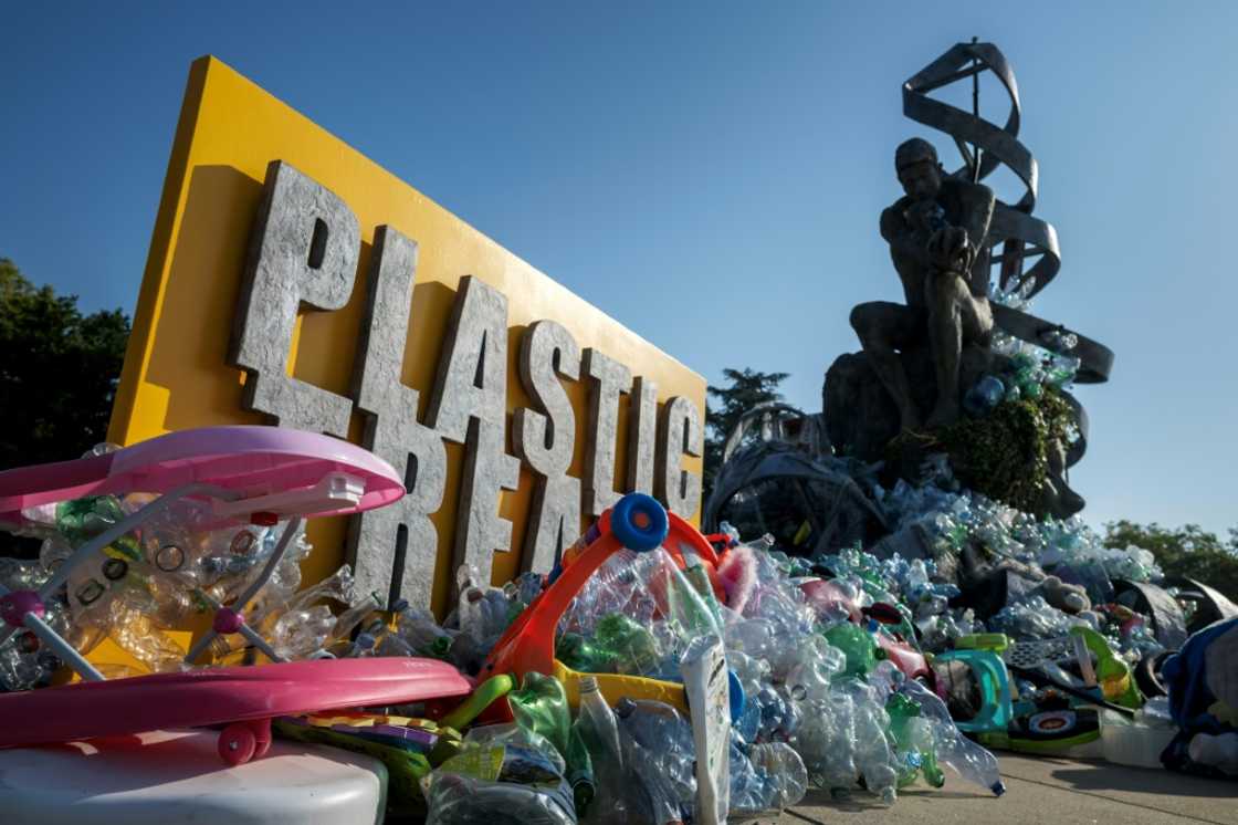 Canadian artist Benjamin Von Wong's sculpture 'The Thinker's Burden', sited outside the UN, is being slowly covered in plastic during the treaty talks in Geneva