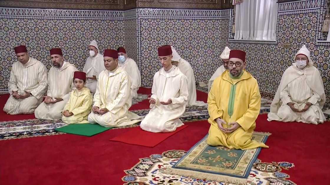 Wearing a yellow robe and appearing thinner, Morocco's King Mohammed VI was seen smiling at the end of the prayers next to his son and his brother Prince Moulay Rachid, 52, images broadcast on public television showed Wearing a yellow robe and appearing thinner, Morocco's King Mohammed VI was seen smiling at the end of the prayers next to his son and his brother Prince Moulay Rachid, 52, images broadcast on public television showed