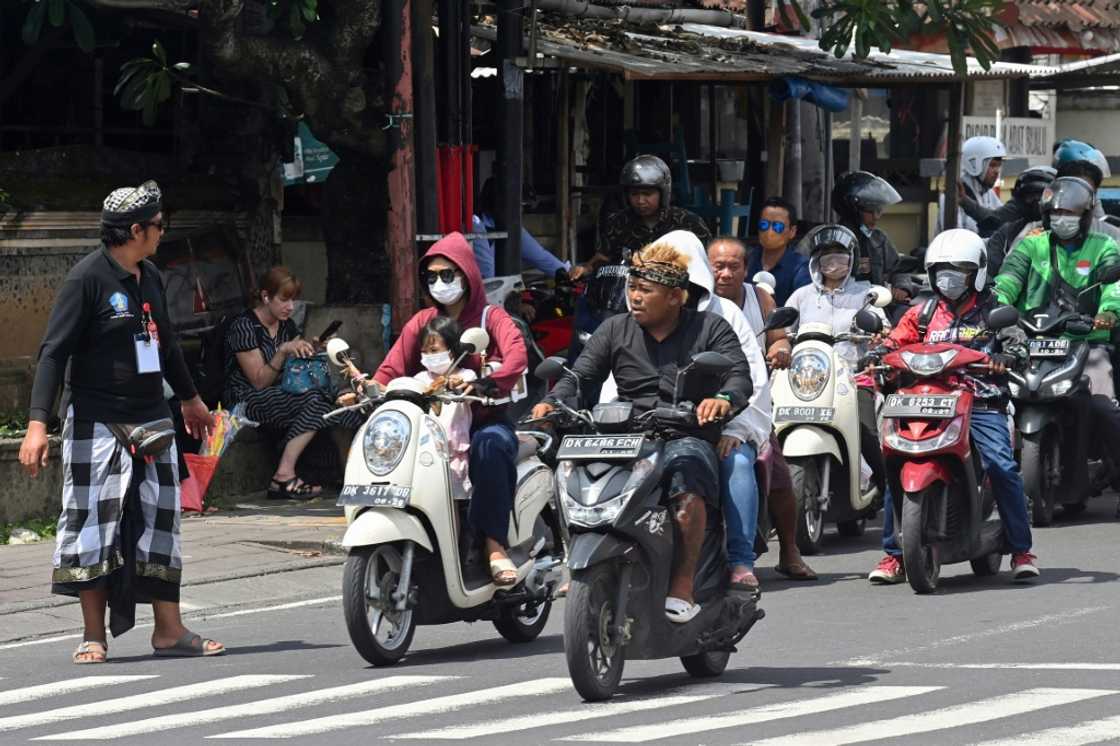 A security officer manages traffic as the motorcade of US President Joe Biden passes by during the G20 summit in Nusa Dua on the Indonesian resort island of Bali A security officer manages traffic as the motorcade of US President Joe Biden passes by during the G20 summit in Nusa Dua on the Indonesian resort island of Bali