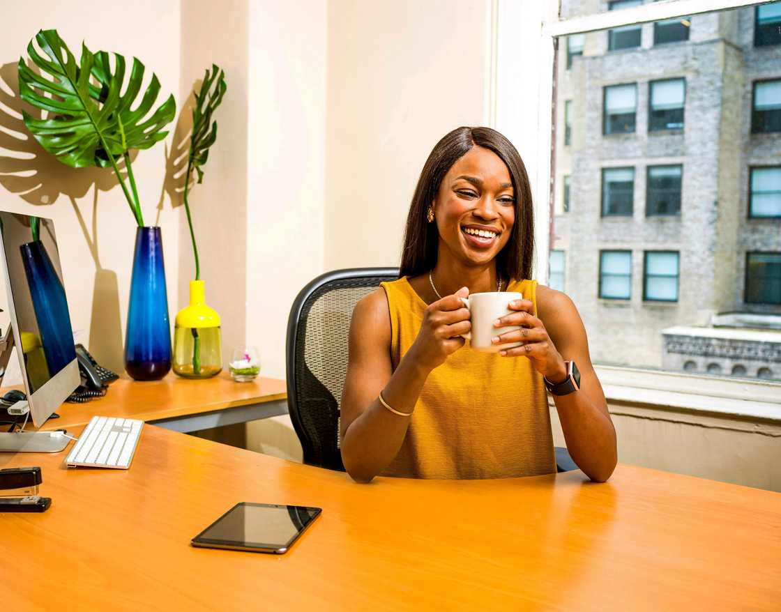 A smiling woman posing in her office