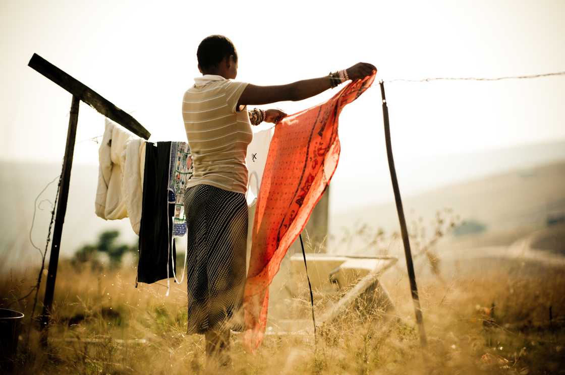 A woman hanging laundry A woman hanging laundry