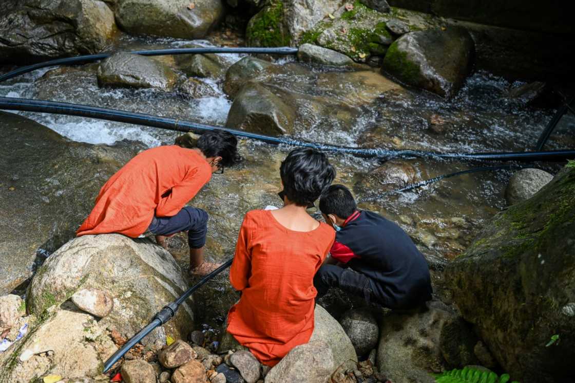 Loh Siew Hong's three children play by a river in Gombak, Malaysia's Selangor state Loh Siew Hong's three children play by a river in Gombak, Malaysia's Selangor state