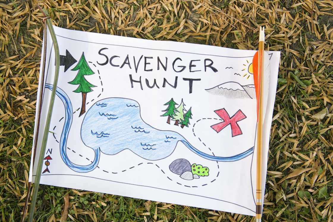 A colourful scavenger hunt map on the ground. A colourful scavenger hunt map on the ground.
