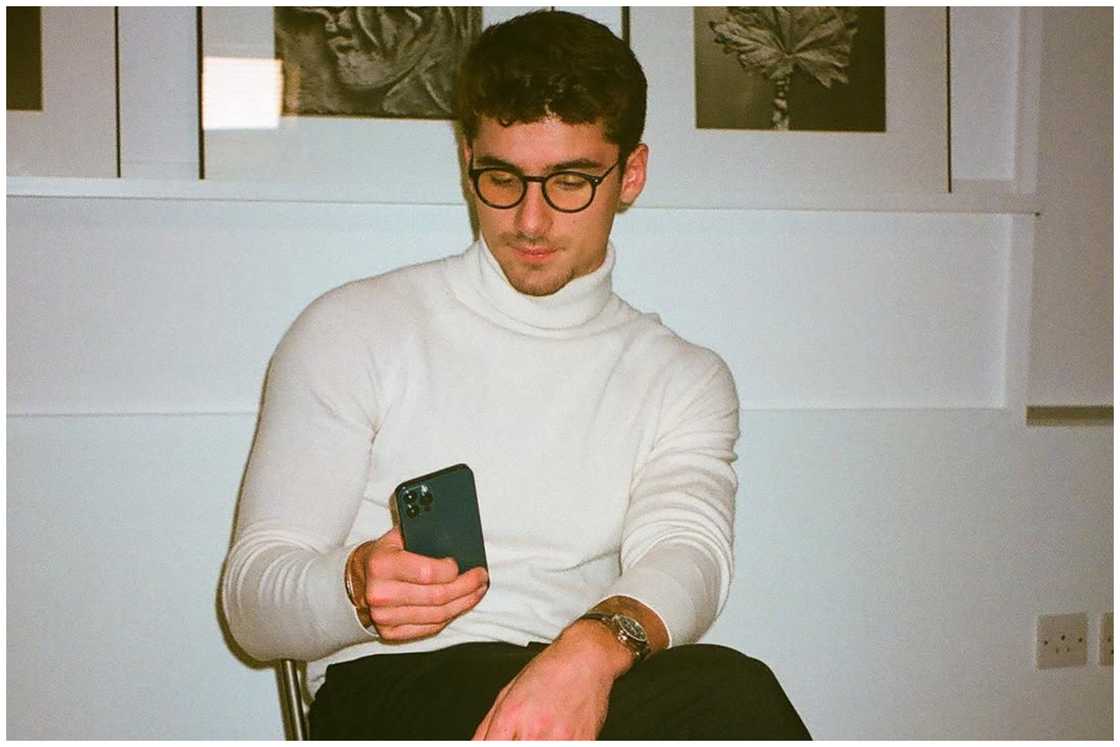 Iman Gadzhi staring at his phone. Iman Gadzhi staring at his phone.