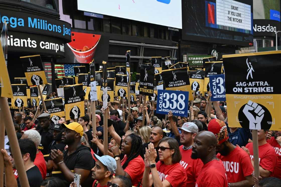 Screen Actors Guild (SAG-AFTRA) members and supporters cheer at a strike rally in Times Square