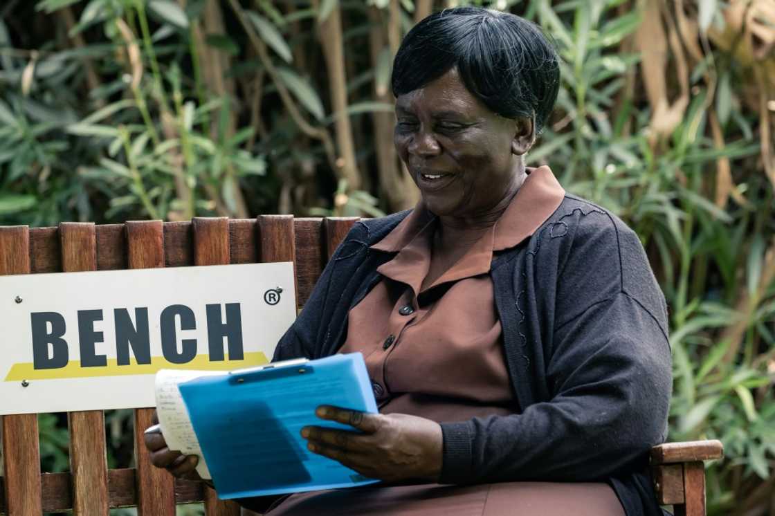 Grandma Shery Ziwakayi sits on a bench with a client during a counselling session at the Friendship Bench in Harare. A Zimbabwean doctor has come up with a novel way of providing desperately needed, yet free mental health therapy for Zimbabweans using elderly lay health workers.