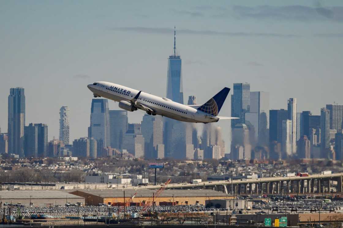 The New York City skyline is seen past a United Airlines aircraft during takeoff at Newark Liberty International Airport in Newark, New Jersey The New York City skyline is seen past a United Airlines aircraft during takeoff at Newark Liberty International Airport in Newark, New Jersey
