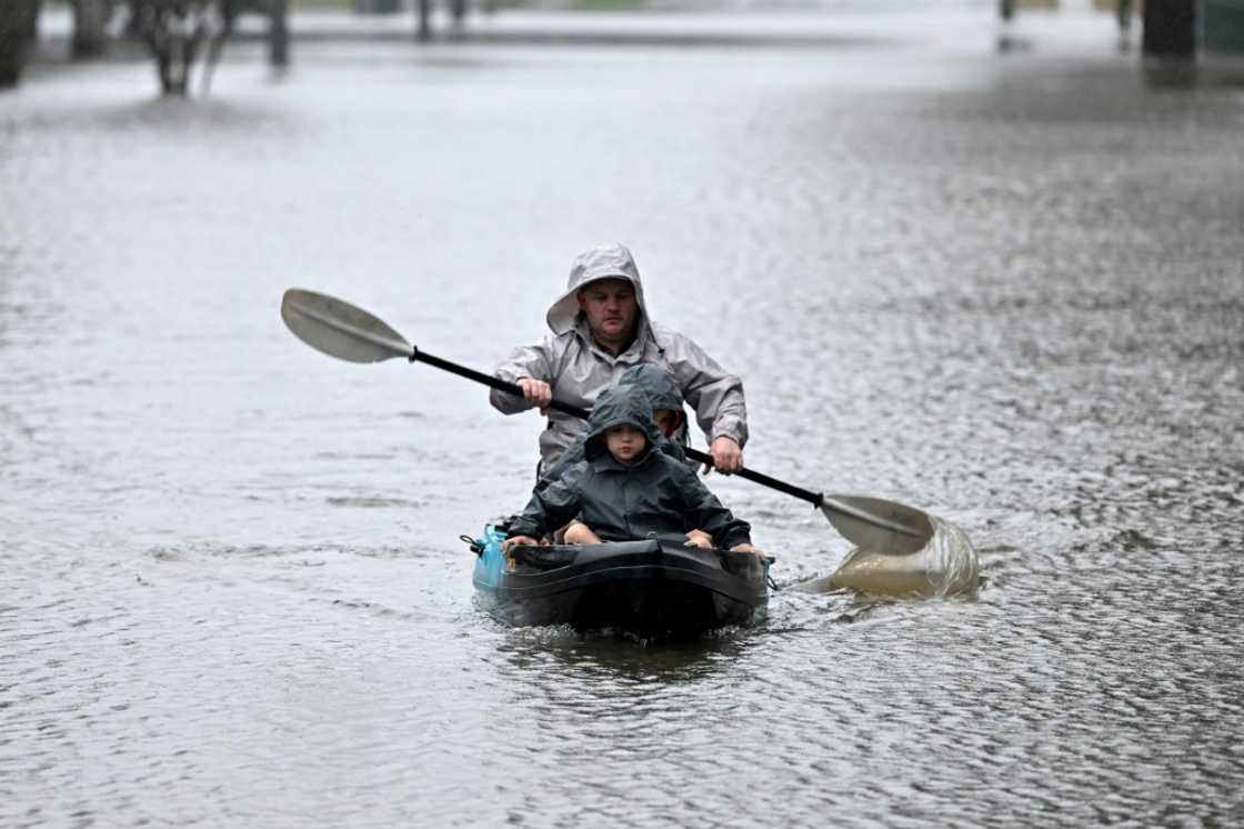 Rain-swollen rivers spilled mud-brown waters across swathes of Sydney, swamping homes and roads while forcing thousands to flee Rain-swollen rivers spilled mud-brown waters across swathes of Sydney, swamping homes and roads while forcing thousands to flee