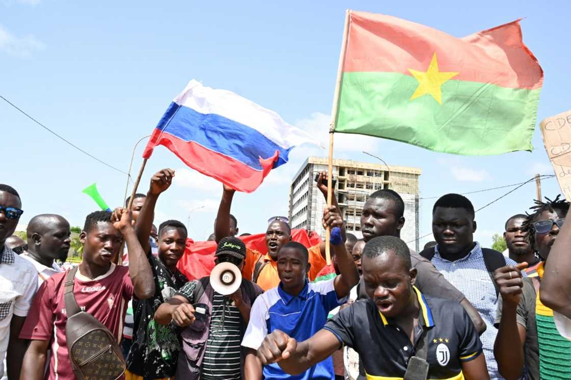 Demonstrators waved Russian and Burkina flags in a protest against West African bloc ECOWAS Demonstrators waved Russian and Burkina flags in a protest against West African bloc ECOWAS