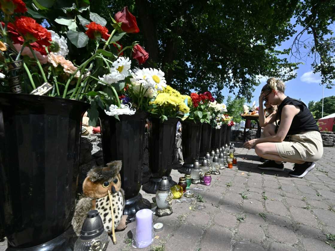 Local people laid flowers and left children's toys next to the burnt-out store