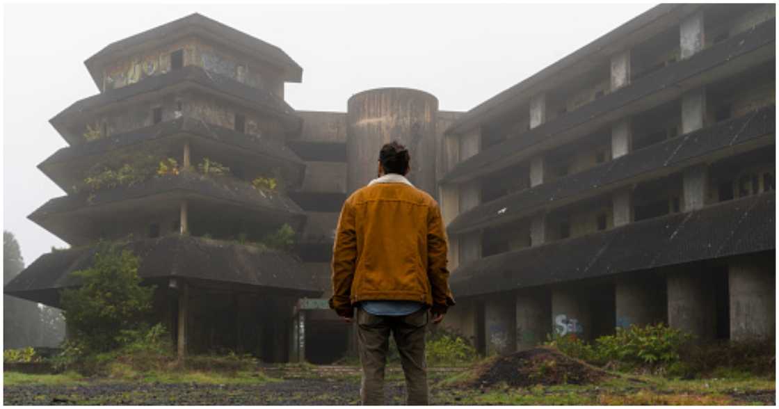 A man stares at a mysterious-looking structure