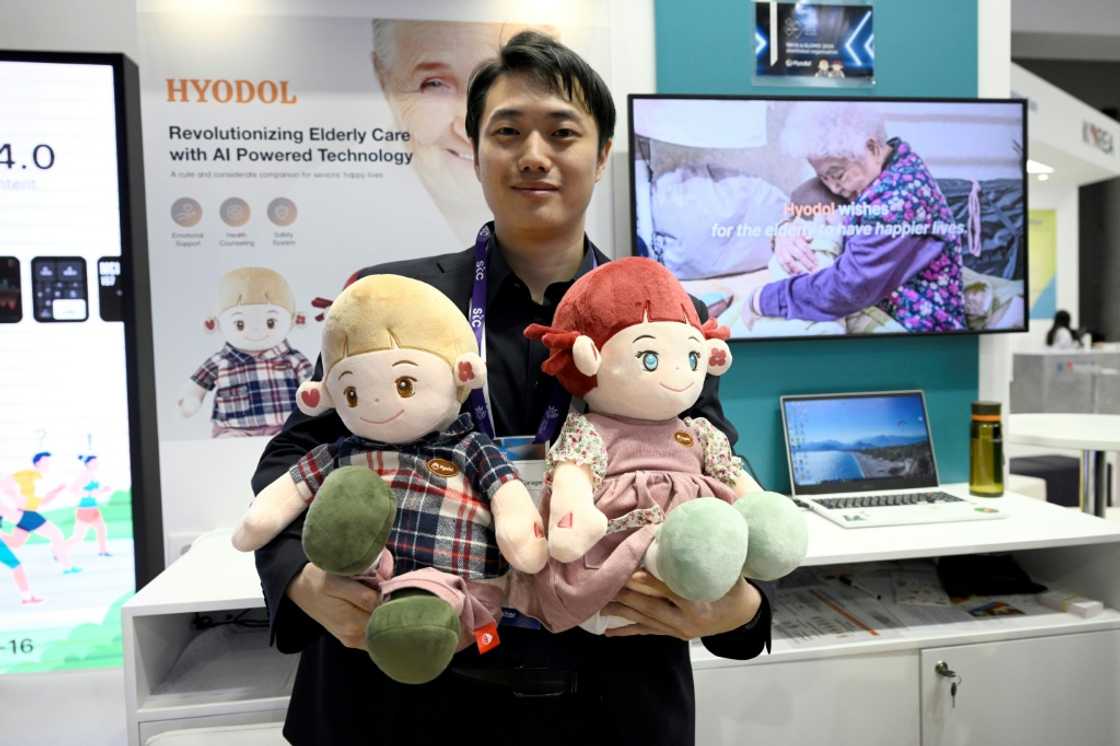 An employee of South Korean company Hyodol holds AI-powered dolls meant to provide companionship to elderly people An employee of South Korean company Hyodol holds AI-powered dolls meant to provide companionship to elderly people
