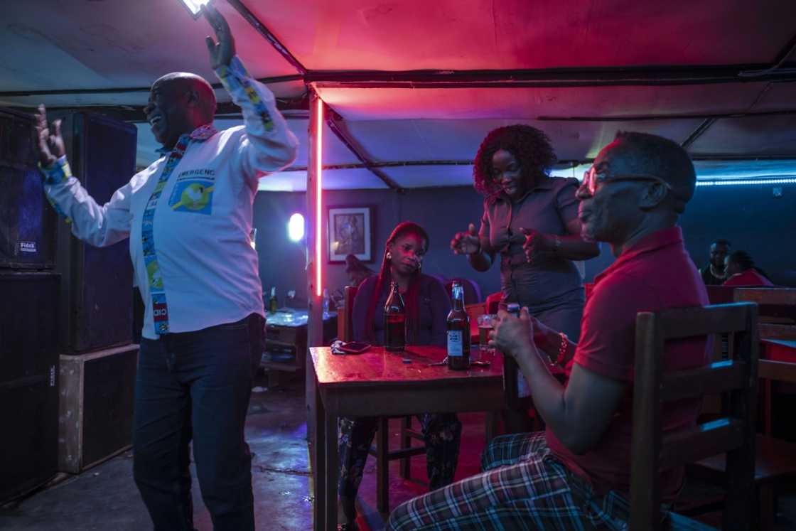 Machozi Binego, who was dancing at the same bar with a group of friends, was similarly cheerful Machozi Binego, who was dancing at the same bar with a group of friends, was similarly cheerful