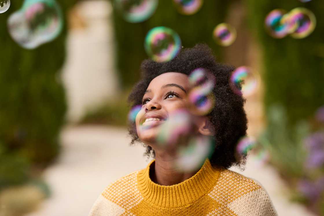Cute girl looking at bubbles