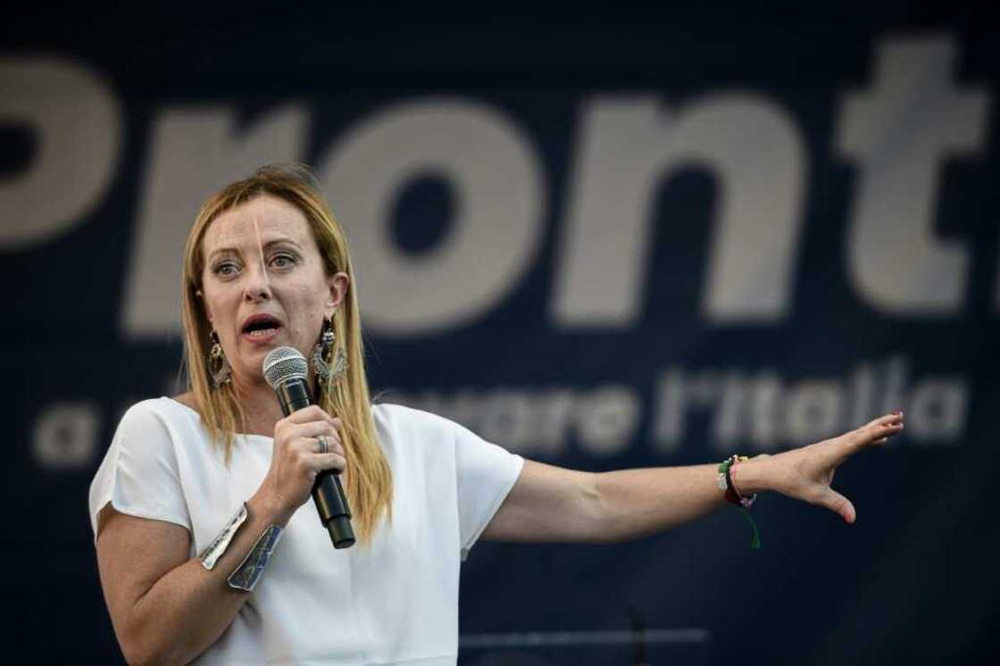 Brothers of Italy leader Giorgia Meloni addresses supporters during a rally, her election slogan "Pronti", or "Ready", behind her Brothers of Italy leader Giorgia Meloni addresses supporters during a rally, her election slogan "Pronti", or "Ready", behind her