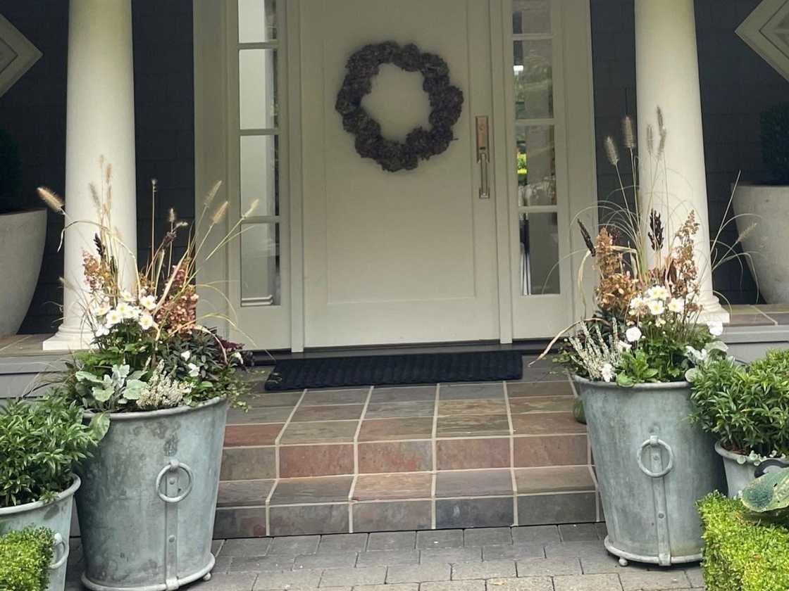 A vintage touch of galvanised planters and a wreath at the door