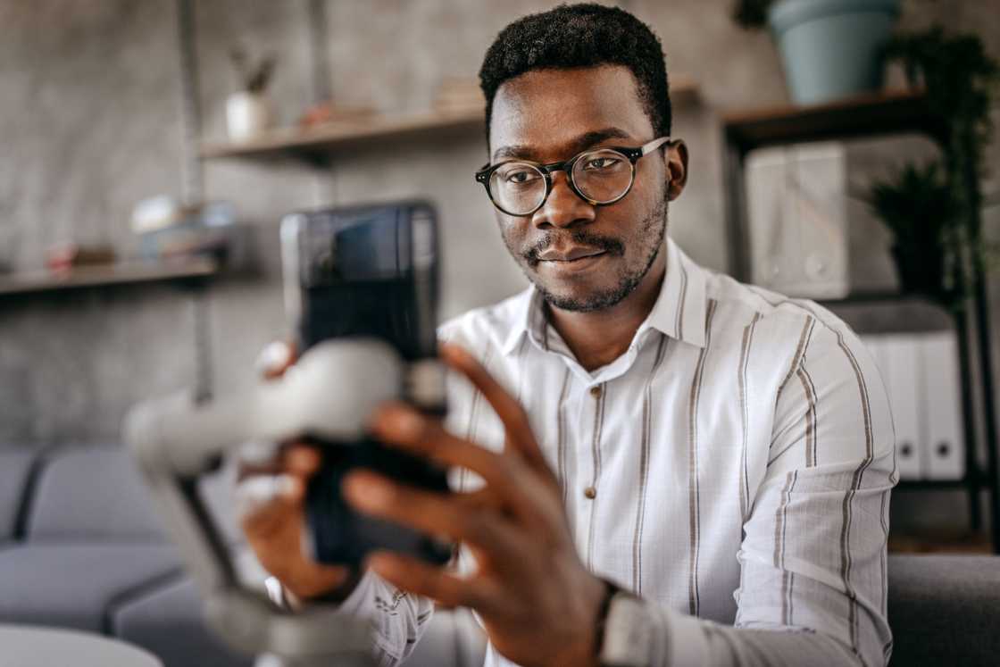 A man is recording a video with his phone