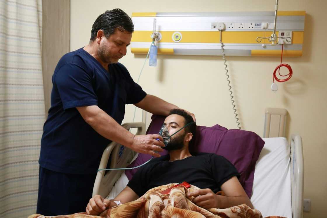A medic helps a man suffering from breathing difficulties after inhaling chlorine gas during Monday's leak in the Jordanian port of Aqaba A medic helps a man suffering from breathing difficulties after inhaling chlorine gas during Monday's leak in the Jordanian port of Aqaba