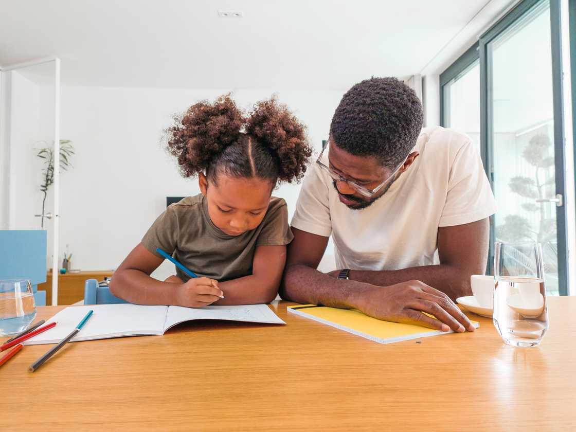A father helping his daughter with homework
