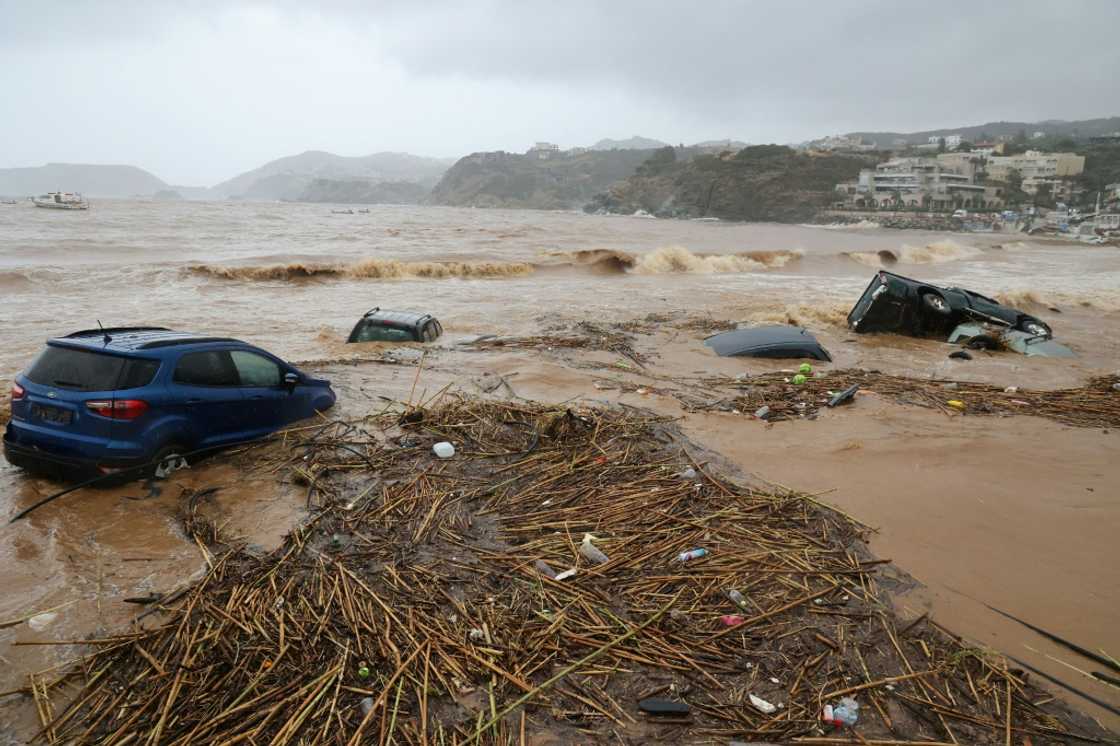 Cars are carried away by floods at the beach of the popular resort of Agia Pelagia, on the southern Greek island of Crete, following flash floods on October 15, 2022 Cars are carried away by floods at the beach of the popular resort of Agia Pelagia, on the southern Greek island of Crete, following flash floods on October 15, 2022