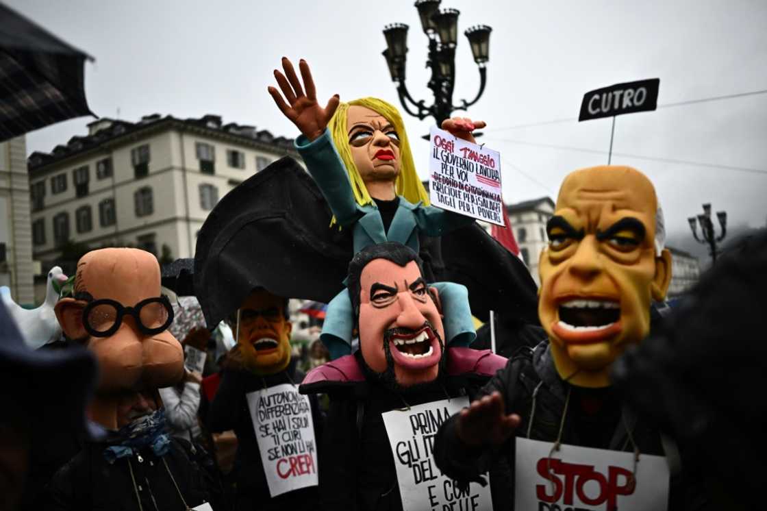 Demonstrators with a puppet of Italy's Prime Minister Giorgia Meloni, centre, at a May Day rally in Turin Demonstrators with a puppet of Italy's Prime Minister Giorgia Meloni, centre, at a May Day rally in Turin