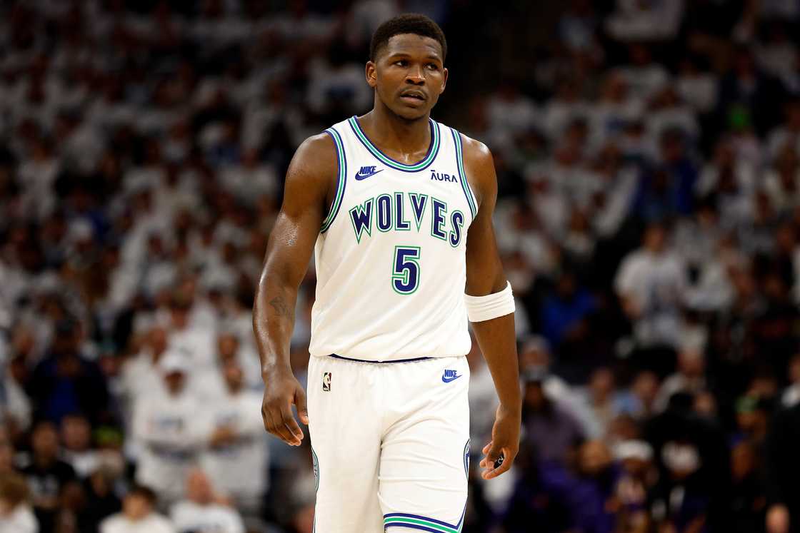 Anthony Edwards looks on during an NBA game. Anthony Edwards looks on during an NBA game.