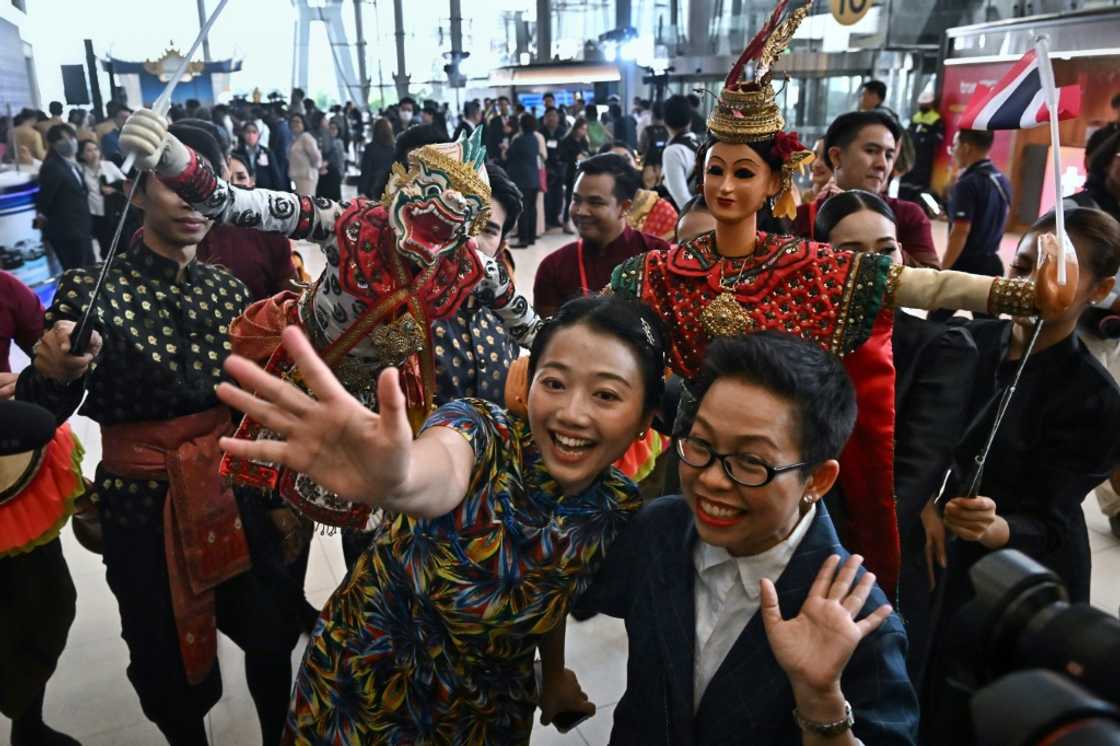 Chinese tourists are greeted by Thai dancers at Suvarnabhumi International Airport in Bangkok Chinese tourists are greeted by Thai dancers at Suvarnabhumi International Airport in Bangkok