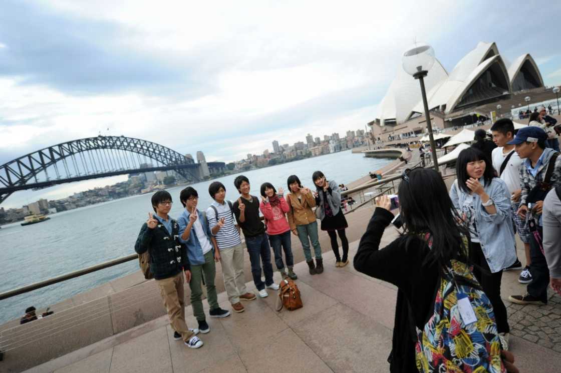 A group of Japanese tourists pose for photographs at Sydney Harbour in 2012. Today around 17.5 percent of Japanese citizens hold valid passports A group of Japanese tourists pose for photographs at Sydney Harbour in 2012. Today around 17.5 percent of Japanese citizens hold valid passports