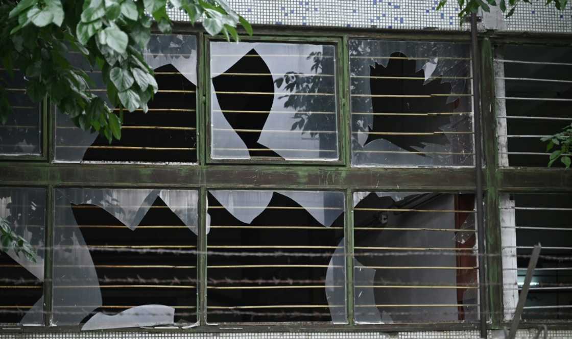 The broken windows of a nearby building