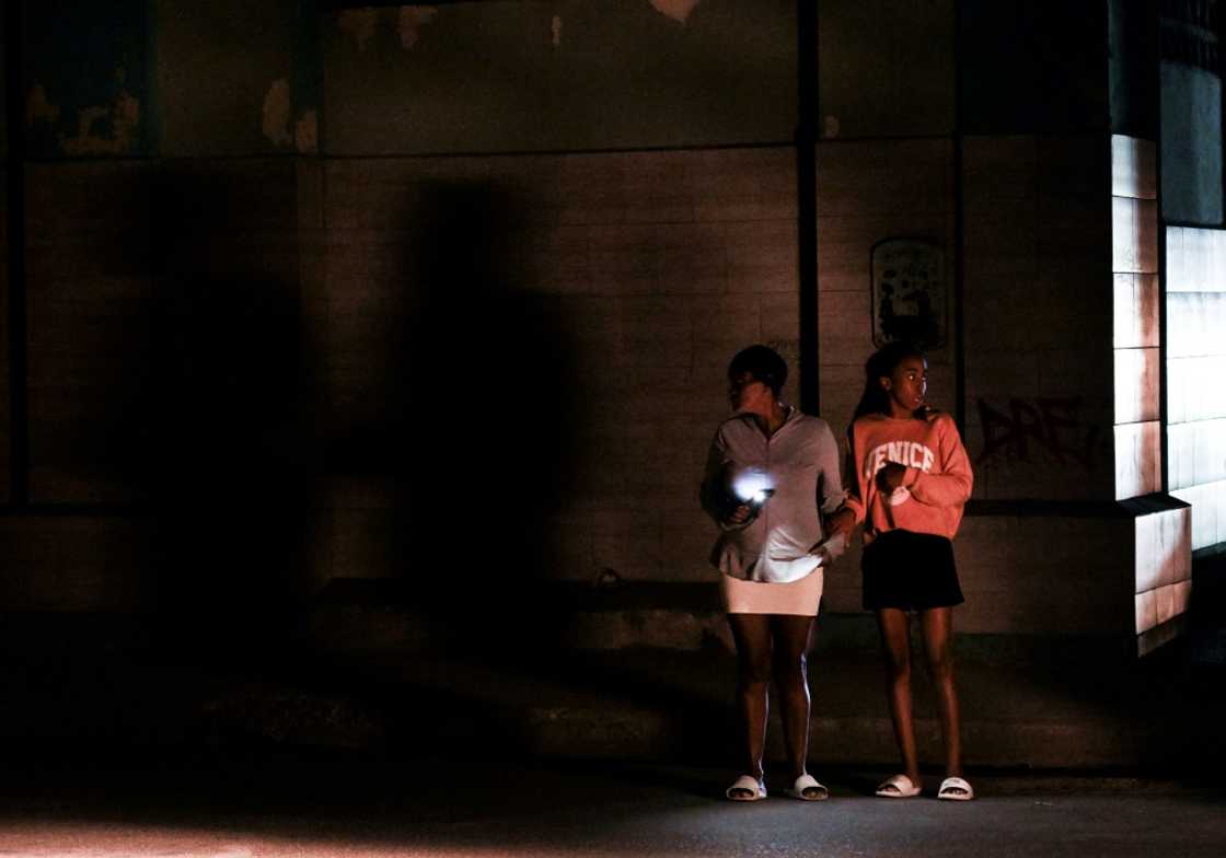 Cubans stand on a corner during a general blackout in Havana on March 14, 2025 Cubans stand on a corner during a general blackout in Havana on March 14, 2025
