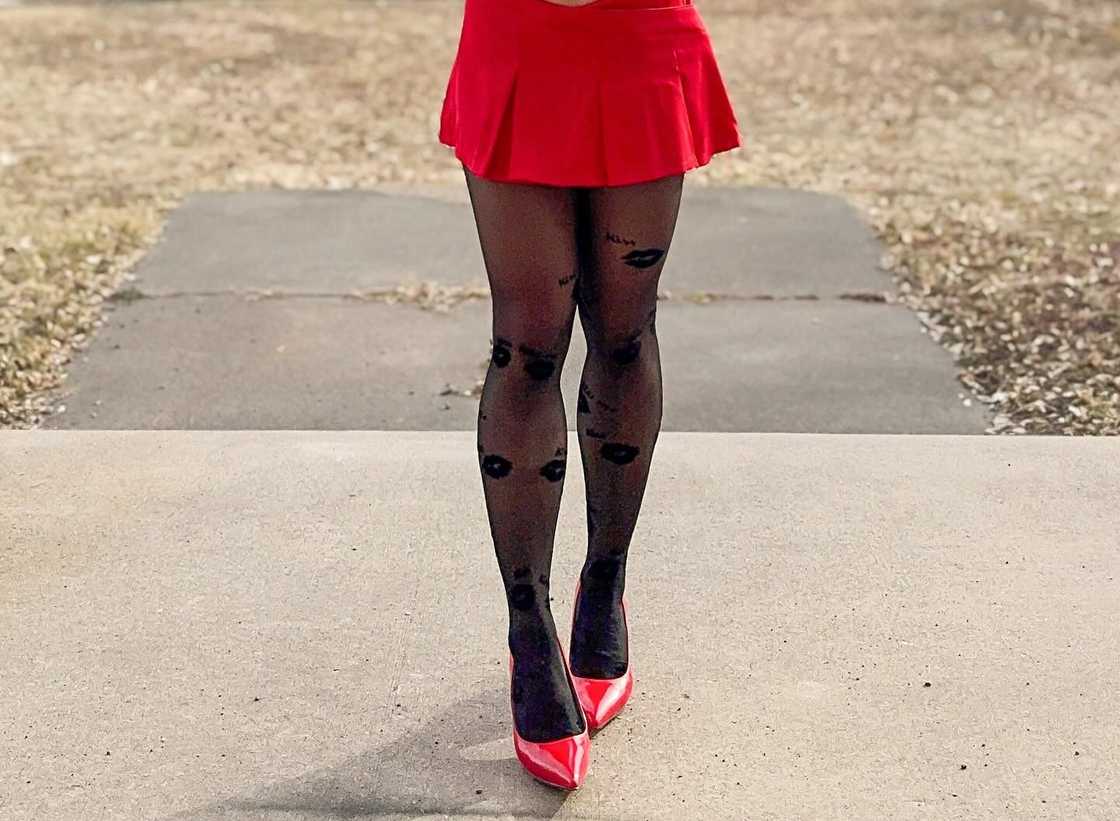 A stylish lady pairs a red mini skirt with a pair of red shoes A stylish lady pairs a red mini skirt with a pair of red shoes