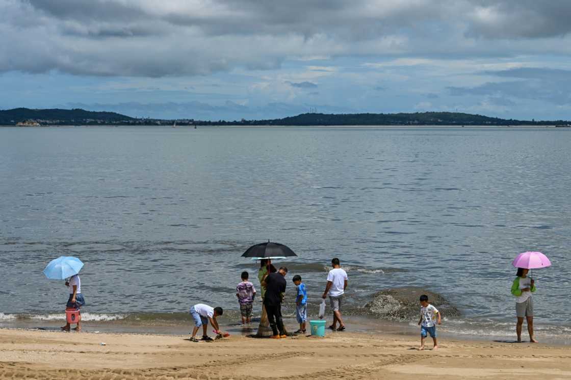 People gather at the beach in Xiamen, across from Taiwan's Kinmen Island