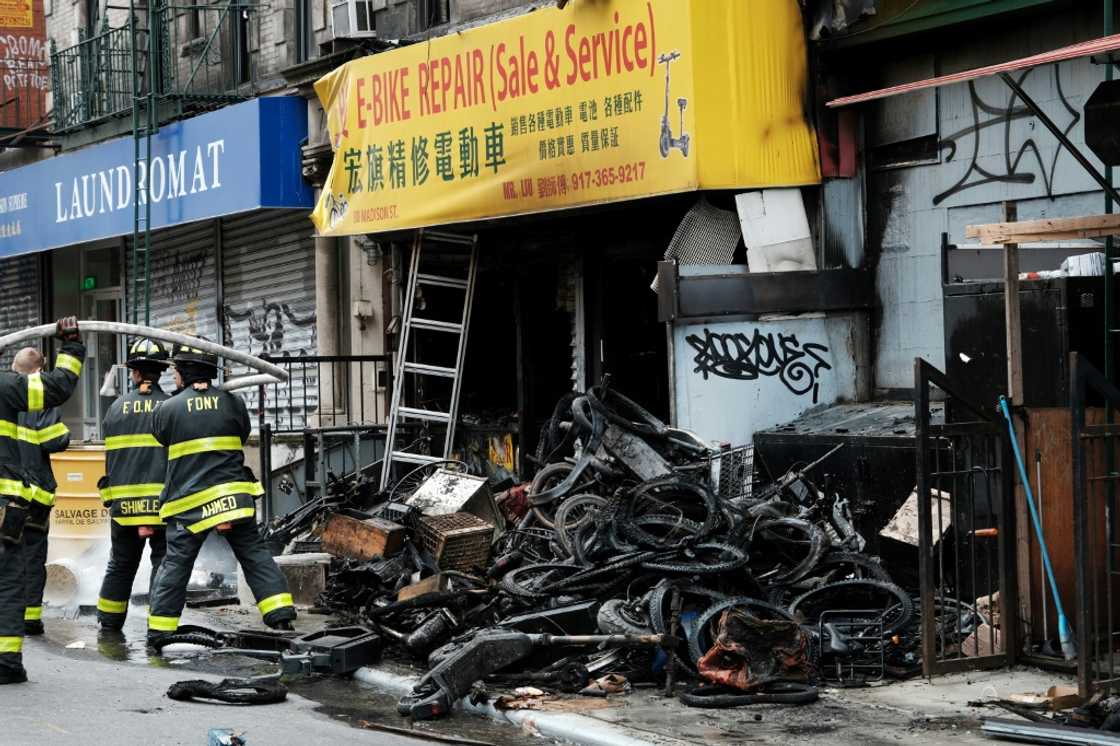 A pile of charred e-bikes lies outside the building where four people died due to the fire A pile of charred e-bikes lies outside the building where four people died due to the fire