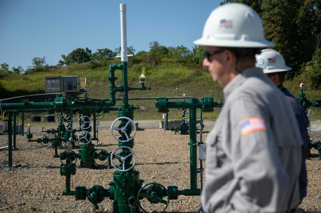 Diversified Energy employees stand next to a natural gas well in Franklin Township, Washington County, Pennsylvania