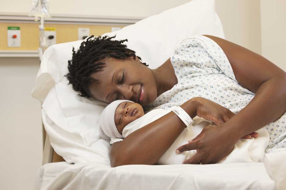 Black woman holding newborn baby