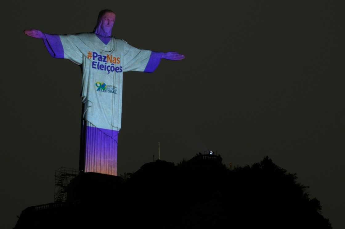 The Christ the Redeemer statue is illuminated with the message "Peace in the Elections" in Rio de Janeiro on October 1, 2022 The Christ the Redeemer statue is illuminated with the message "Peace in the Elections" in Rio de Janeiro on October 1, 2022