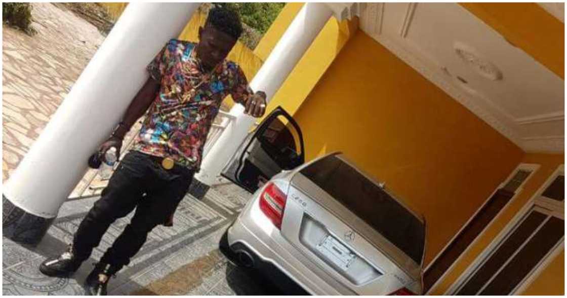Shatta Wale poses in front of the house Shatta Wale poses in front of the house