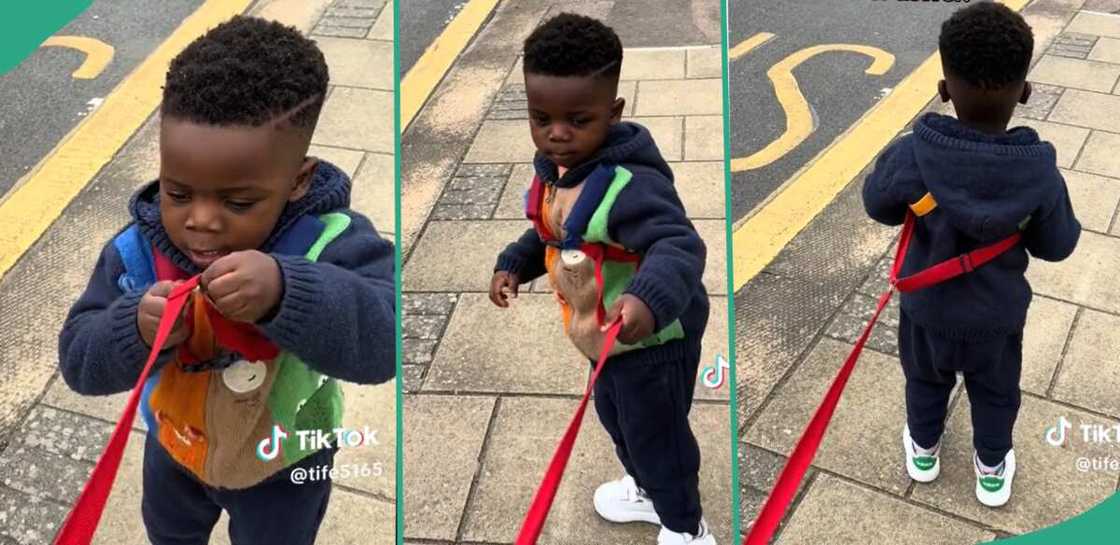 Nigerian mother uses rope to hold her son.