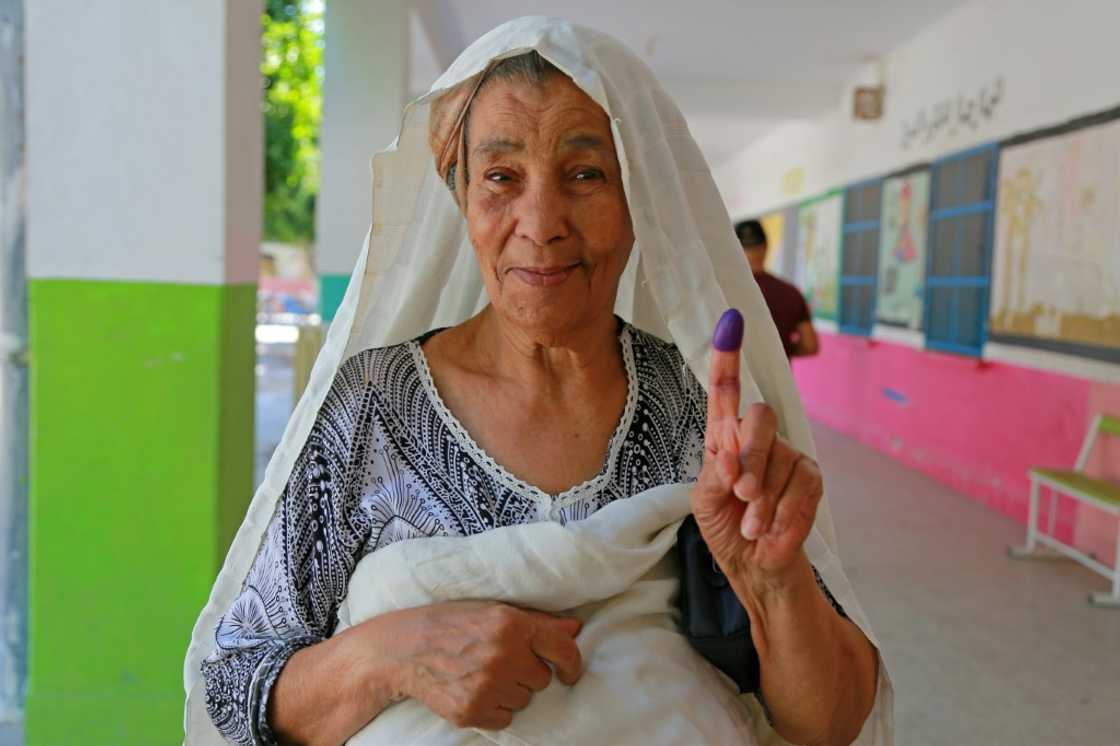 A Tunisian woman shows her ink-stained finger after voting in the referendum A Tunisian woman shows her ink-stained finger after voting in the referendum