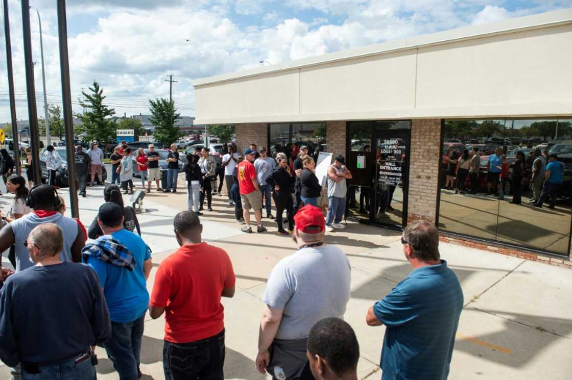 Members of the United Auto Workers (UAW) line up outside of the UAW Local 900 headquarters to sign up for strike funds