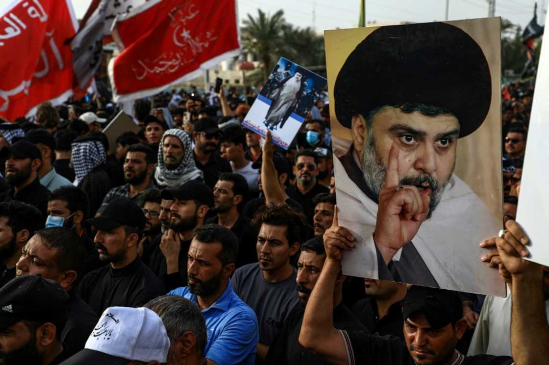 Supporters of Shiite cleric Moqtada Sadr carry portraits of him as they gather in the southern Iraqi city of Nasiriyah Supporters of Shiite cleric Moqtada Sadr carry portraits of him as they gather in the southern Iraqi city of Nasiriyah