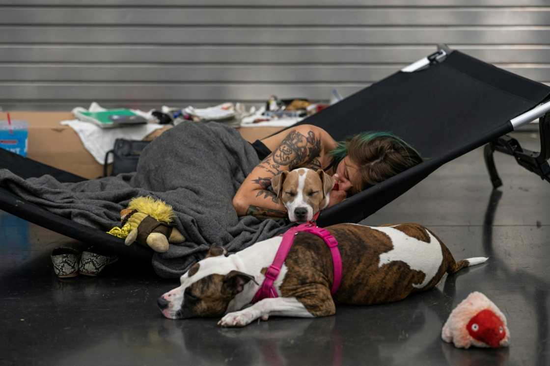 Austun Wilde rests with her two dogs, Bird Is The Wurd and Fenrir at a cooling center in the Oregon Convention Center on June 27, 2021 in Portland; Multnomah County is suing fossil fuel companies for damages caused by climate change Austun Wilde rests with her two dogs, Bird Is The Wurd and Fenrir at a cooling center in the Oregon Convention Center on June 27, 2021 in Portland; Multnomah County is suing fossil fuel companies for damages caused by climate change
