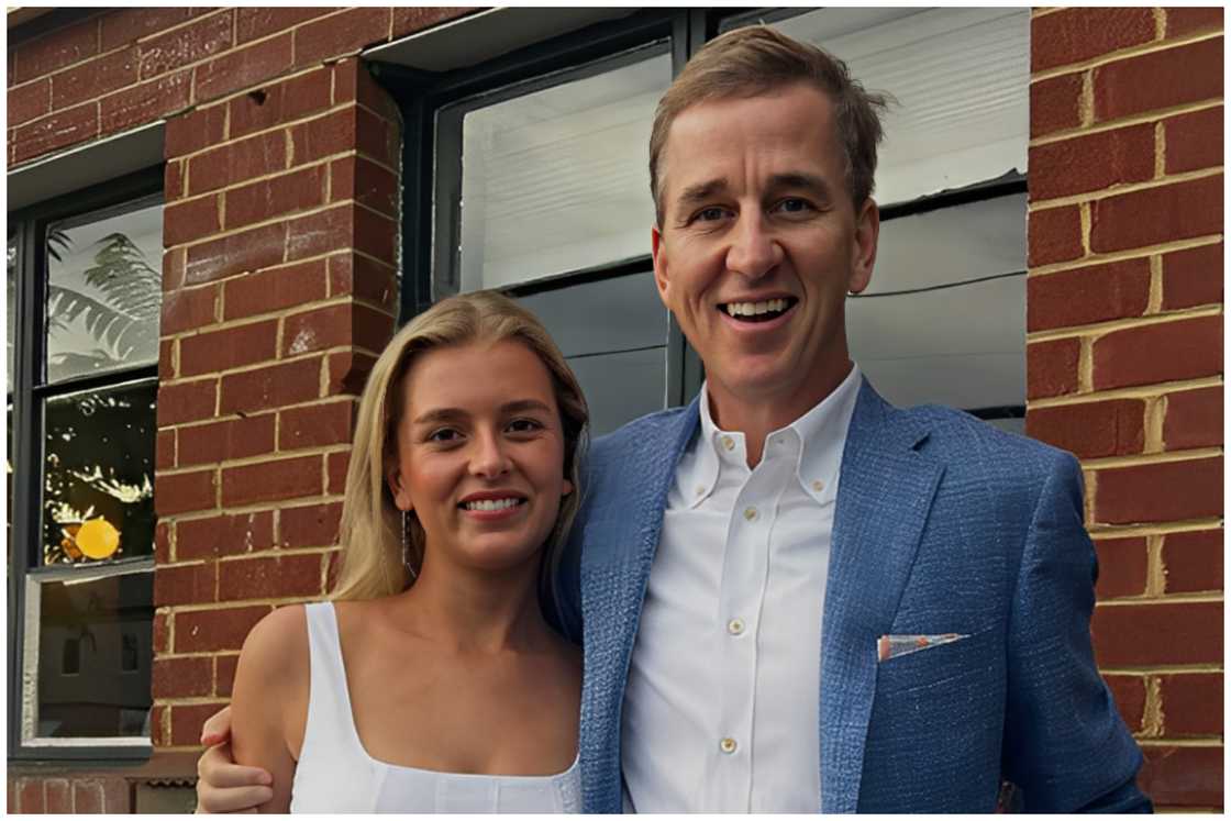 May Manning and her dad, Cooper, are hugging each other sideways. May Manning and her dad, Cooper, are hugging each other sideways.